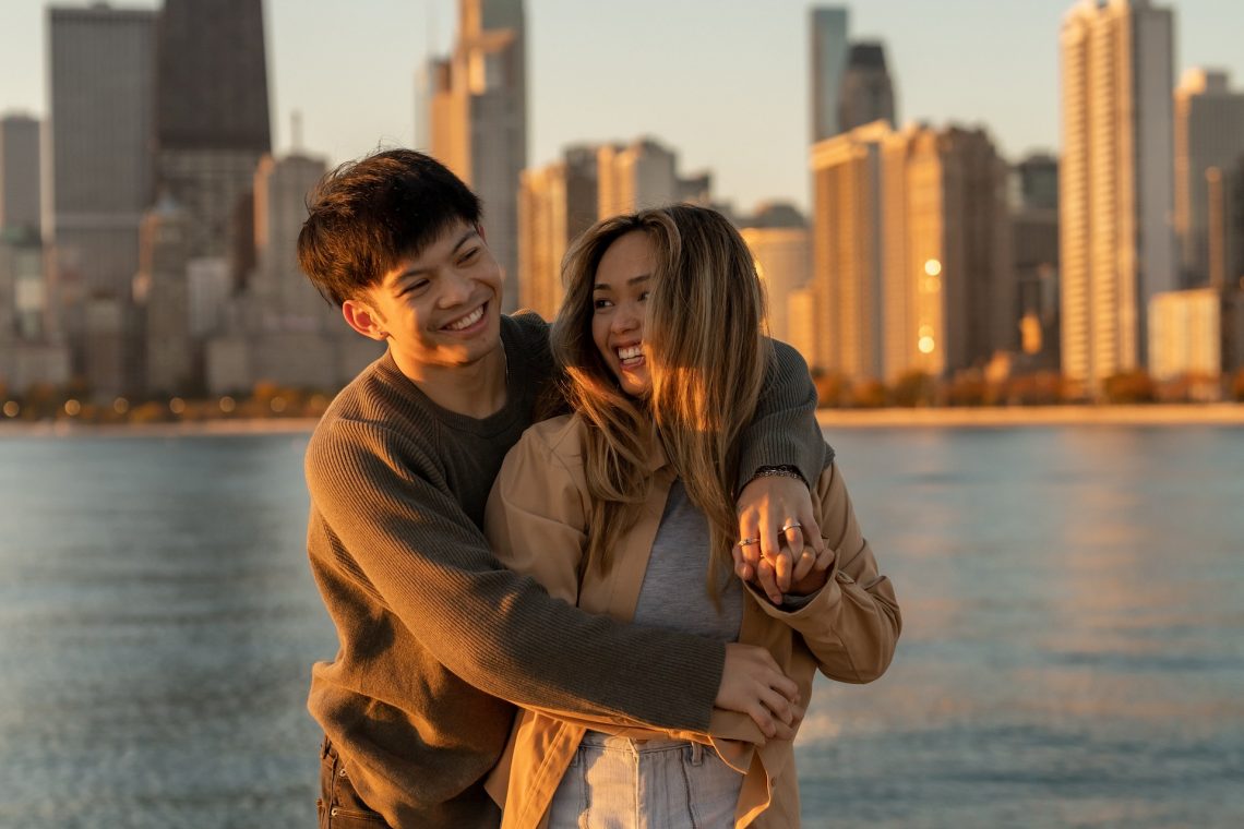 couple hugging on engagement session golden hour