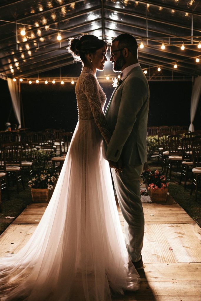wedding planning on your own couple standing on dance floor under string lights